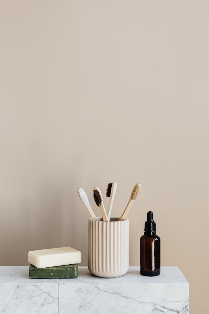 services-04 Minimalist eco-friendly bathroom essentials with bamboo toothbrushes and organic soap on marble.