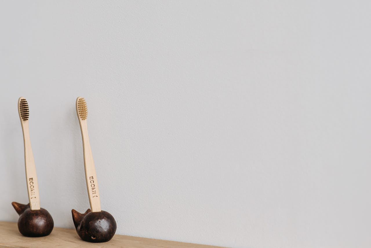 services-02 Pair of eco-friendly wooden toothbrushes in unique holders on a white background, ideal for promoting sustainable oral hygiene.